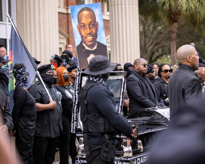 Protesters gather in November 2021 outside the trial of the men who killed Ahmaud Arbery in Brunswick, Ga., in February 2020.