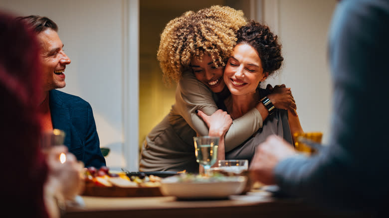 Two women hug