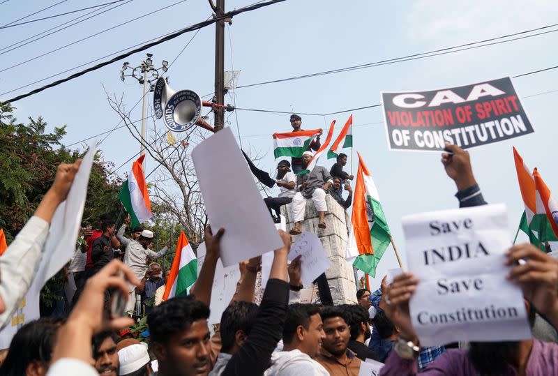 Demonstrators hold placards and flags as they attend a protest rally against a new citizenship law, in Hyderabad