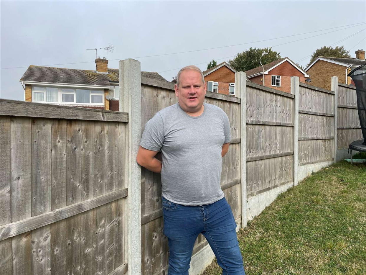 Richard Hickson and his fence. Photo released October 3 2023. See SWNS story SWLSfence. A dad-of-two who bought land next to his house to extend his garden has been told he will have to throw it open to the public.The council has even warned Richard Hickson he faces prosecution and potentially jail if he doesn't take down the fence. Richard paid £5,000 to purchase the “unused” patch of grass in Istead Rise, near Gravesend, from developers P J Brazier and Company Limited in 2018.He spent a further £20,000 to create a suitable garden for his two daughters, aged five and eight, and erected a six-foot fence around the land.
