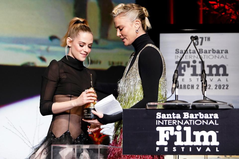 Charlize Theron (R) presents Kristen Stewart (L) with her American Riviera Award at the American Riviera Award tribute during the 37th Annual Santa Barbara International Film Festival at Arlington Theatre on March 04, 2022 in Santa Barbara, California.