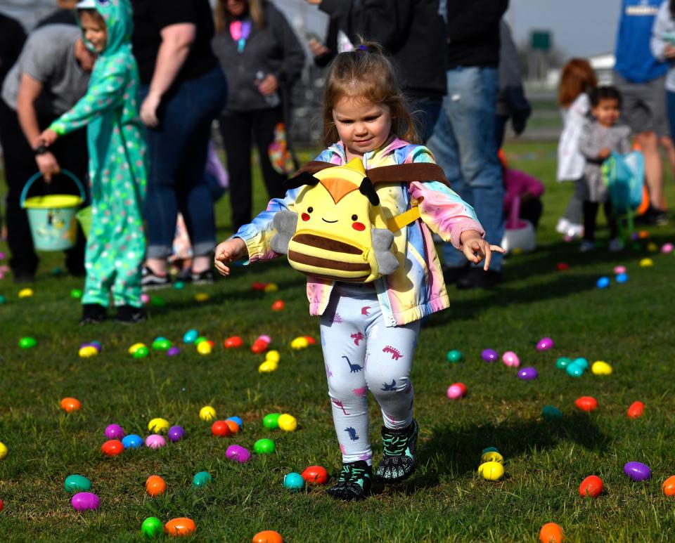 P.J. Smith-Sherman, 2, strapped her backpack on her front to facilitate gather eggs easier at the city Easter egg hunt at Stafford Sports Complex Saturday.