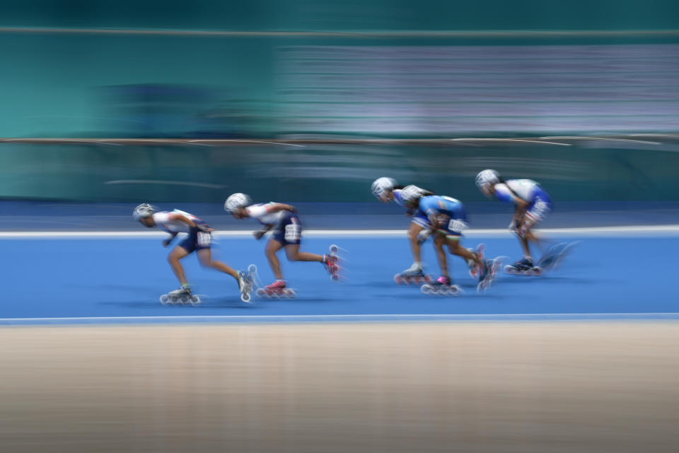 Pei-Yu Shih, left, of Taiwan, leads the pack at the Women's Speed Skating 10000m Point-Elimination Race event of the 19th Asian Games in Hangzhou, China, Saturday, Sept. 30, 2023. (AP Photo/Aaron Favila)