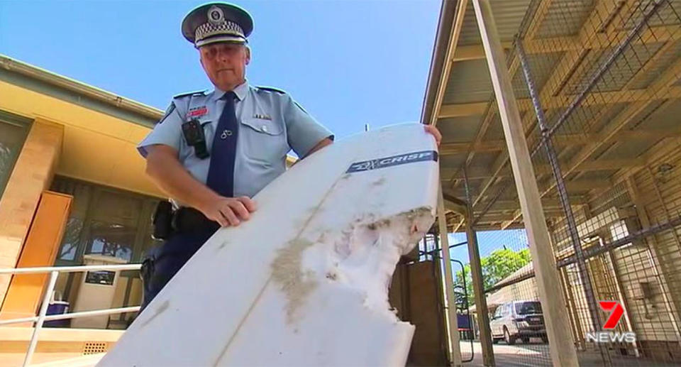 Detective Inspector Matt Kehoe shows the bite mark left on Sam’s surfboard. Source: 7 News