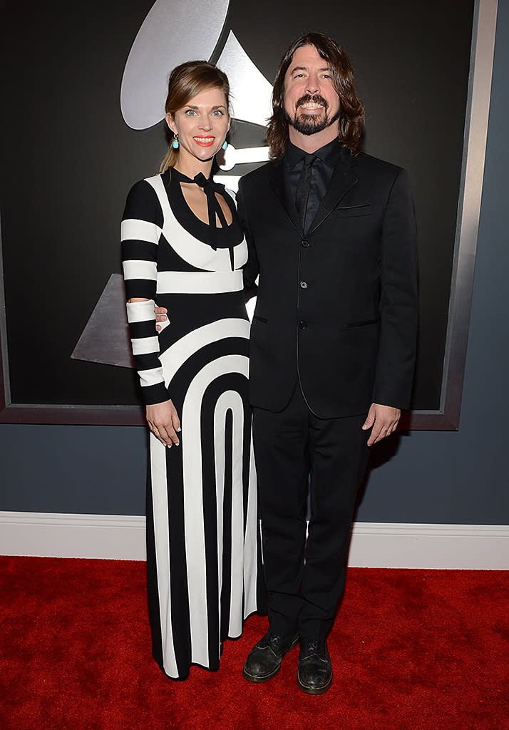 <b>Dave Grohl and Wife Jordan</b><br> <b>Grade: C</b><br> Rocker Dave Grohl and his wife Jordyn color-coordinated in a classic black suit for him and a whimsical-yet-unfortunate black-and-white dress for her.