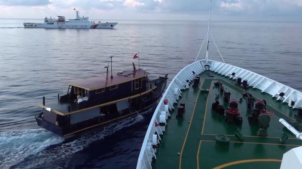 A Philippine flagged boat is blocked by a China Coast Guard vessel