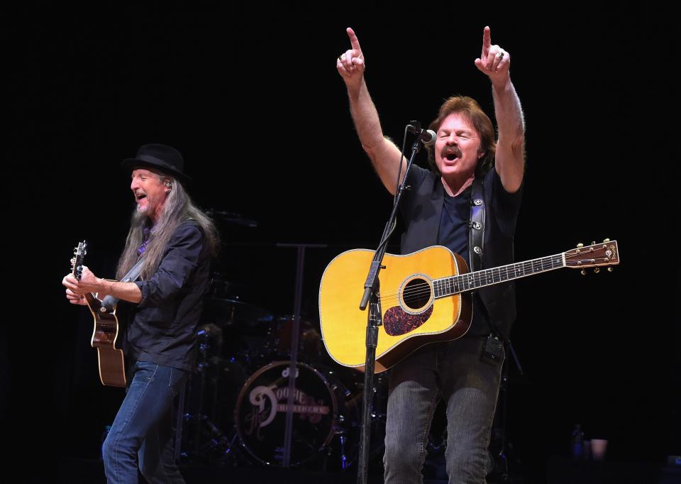 Patrick Simmons, left, and Tom Johnston of the Doobie Brothers perform on stage in Nashville, Tenn., in 2014.