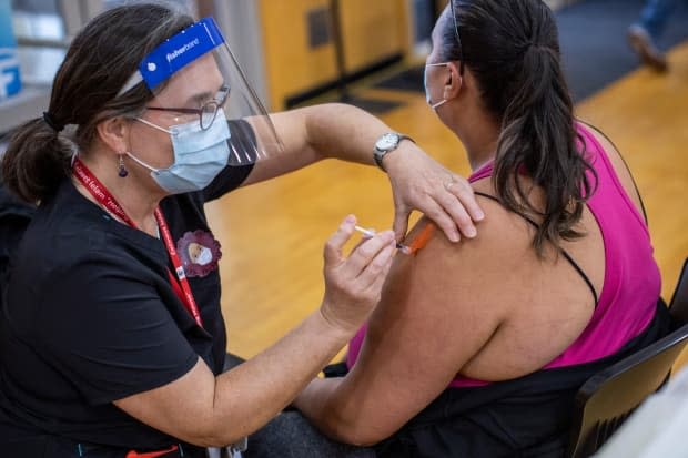 Health-care workers administer the COVID-19 vaccination to members of the Tsleil-Waututh First Nation on March 25. 