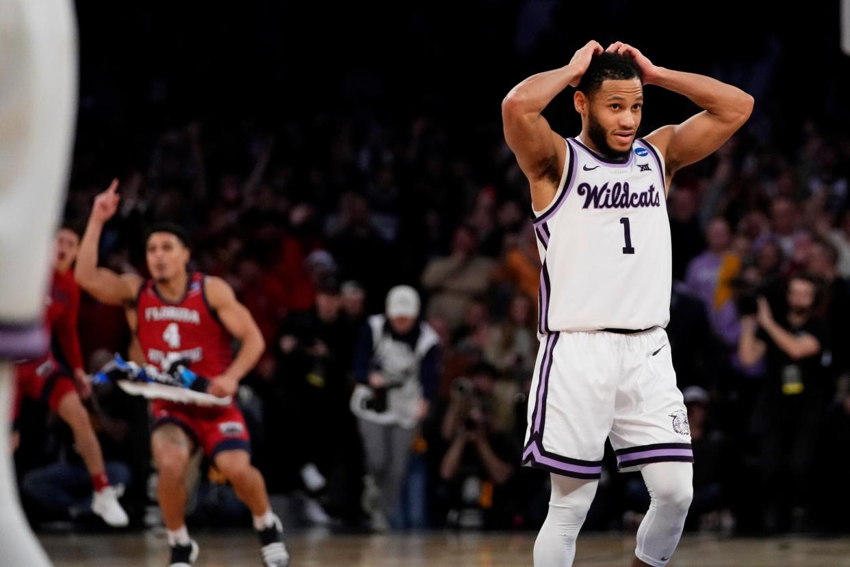 Kansas State guard Markquis Nowell reacts (1) as Florida Atlantic players celebrate following the Owls' 79-76 Elite Eight victory on Saturday night at Madison Square Garden.