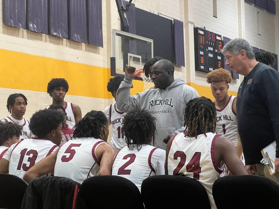 Rock Hill head coach Douglas Pearson (grey hoodie) talks to his team during a timeout in the first half of the team’s 51-42 loss to Marion on Dec. 2 at the Battle of the Rock basketball showcase.