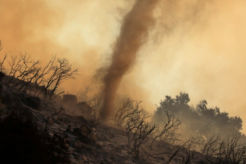 A wildfire dubbed the Cave Fire burns in the hills of Santa Barbara, California,