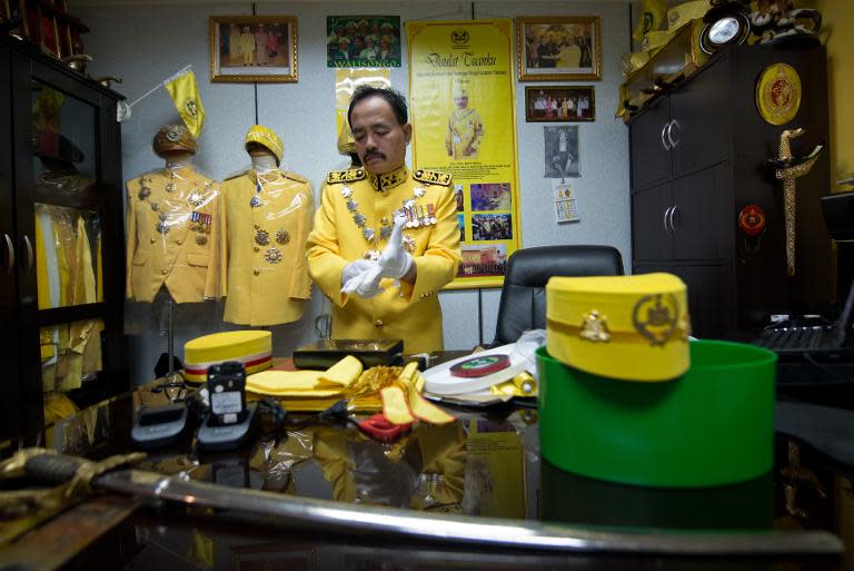 Self-styled royal Raja Noor Jan Shah Raja Tuah Shah wears a royal-yellow military-style suit before attending a private function at a palace in Gombak, on the outskirt of Kuala Lumpur, on September 7, 2013