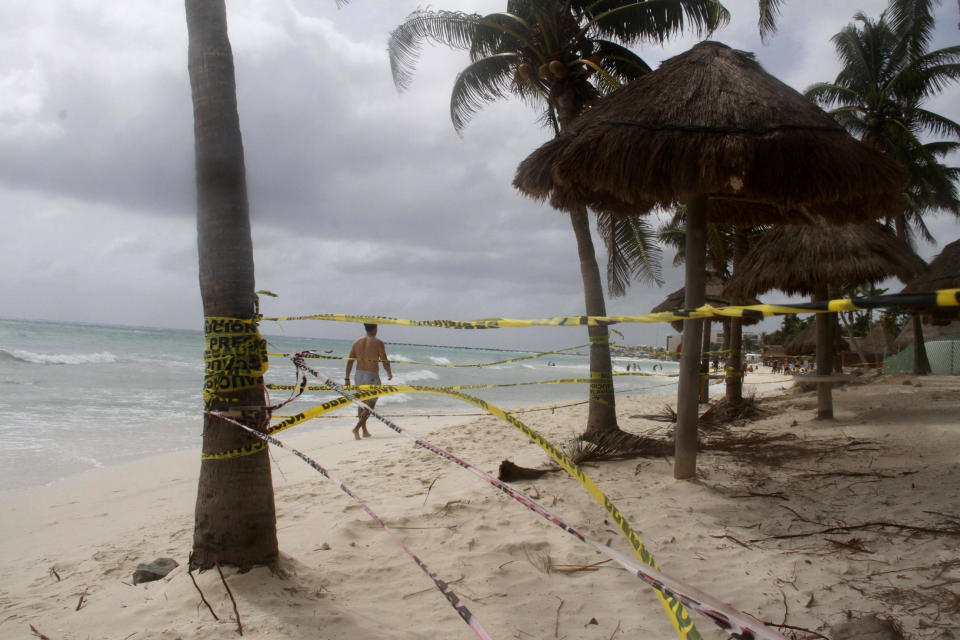 Tape closing off the beach blows in the wind before the arrival of Tropical Storm Zeta in Playa del Carmen, Mexico, Monday, Oct. 26, 2020. A strengthening Tropical Storm Zeta is expected to become a hurricane Monday as it heads toward the eastern end of Mexico's resort-dotted Yucatan Peninsula and then likely move on for a possible landfall on the central U.S. Gulf Coast at midweek. (AP Photo/Tomas Stargardter)