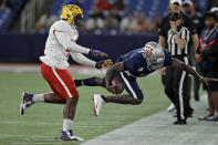 East linebacker Michael Divinity Jr., of LSU, (45) shoves West quarterback Tyler Huntley, of Utah, (1) out of bounds after a run during the second half of the East West Shrine football game Saturday, Jan. 18, 2020, in St. Petersburg, Fla. (AP Photo/Chris O'Meara)