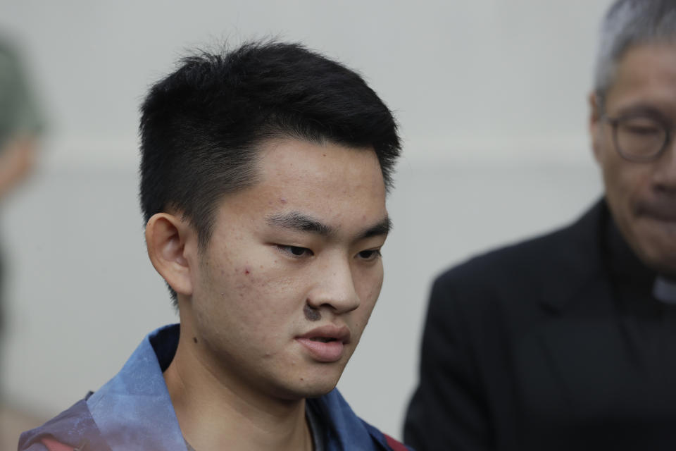 Chan Tong-kai, left, talks to the media as he is released from prison in Hong Kong Wednesday, Oct. 23, 2019. Chan, who's wanted for killing his girlfriend last year on the self-ruled island, had asked the Hong Kong government for help turning himself in to Taiwan after his sentence for money laundering offenses ends on Wednesday. (AP Photo/Mark Schiefelbein)