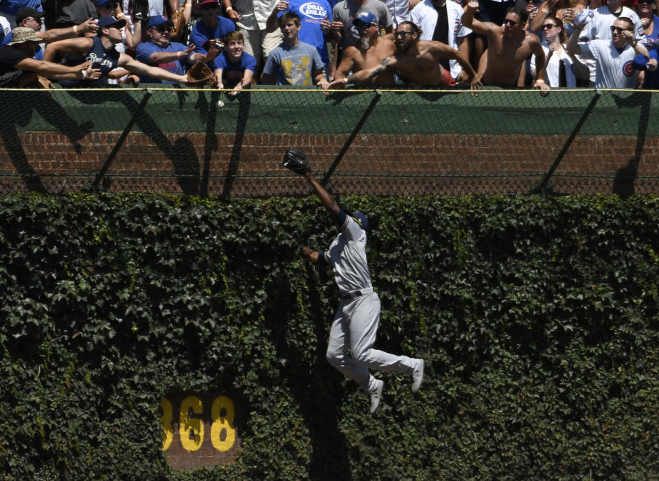 Milwaukee Brewers center fielder Lorenzo Cain (6) can't catch a ball hit for a home run by Chicago Cubs' Jason Heyward (22) during the first inning of a baseball game, Friday, Aug. 2, 2019, in Chicago. (AP Photo/David Banks)