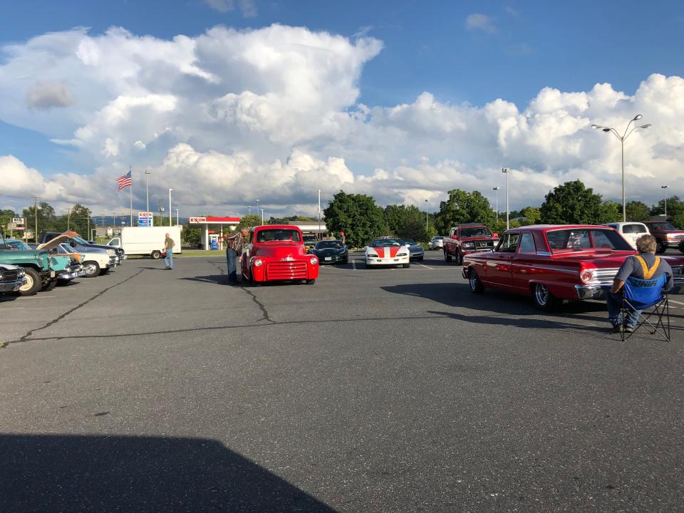 A tiny car show in the parking lot of Sharp Shopper that happens often on a Saturday.