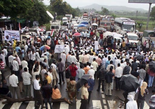 Supporters of anti-corruption activist Anna Hazare participate in a sit-protest as they block the Pune-Ahmednagar Highway leading to Hazare's home village of Ralegan Siddhi, some 240 kms east of Mumbai