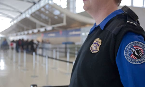 Romulus, Michigan - A security officer watches passengers arriving at Detroit Metropolitan Airport.