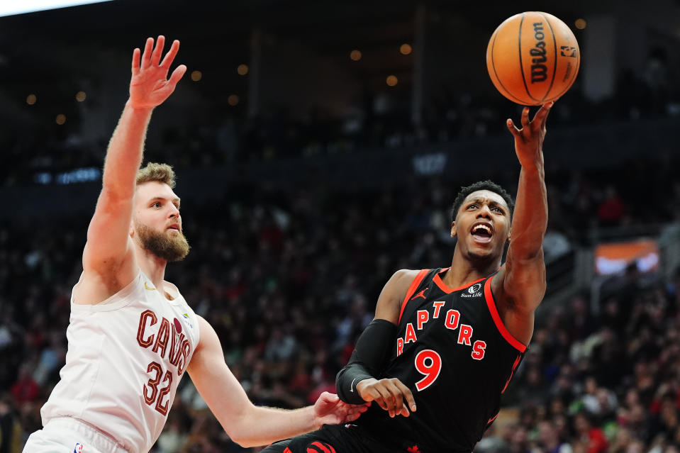 Toronto Raptors guard RJ Barrett (9) shoots past Cleveland Cavaliers forward Dean Wade (32) during the first half of an NBA basketball game, Saturday, Feb. 10, 2024 in Toronto. (Frank Gunn/The Canadian Press via AP)