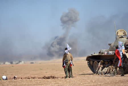 Shi'ite Popular Mobilization Forces (PMF) gather with Iraqi army on the outskirts of Tal Afar, Iraq, August 22, 2017. REUTERS/Stringer