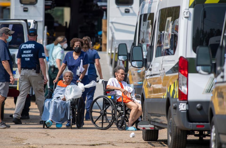 Paramedics evacuate people at a mass shelter on Thursday, Sept. 2, 2021, in Independence, La.