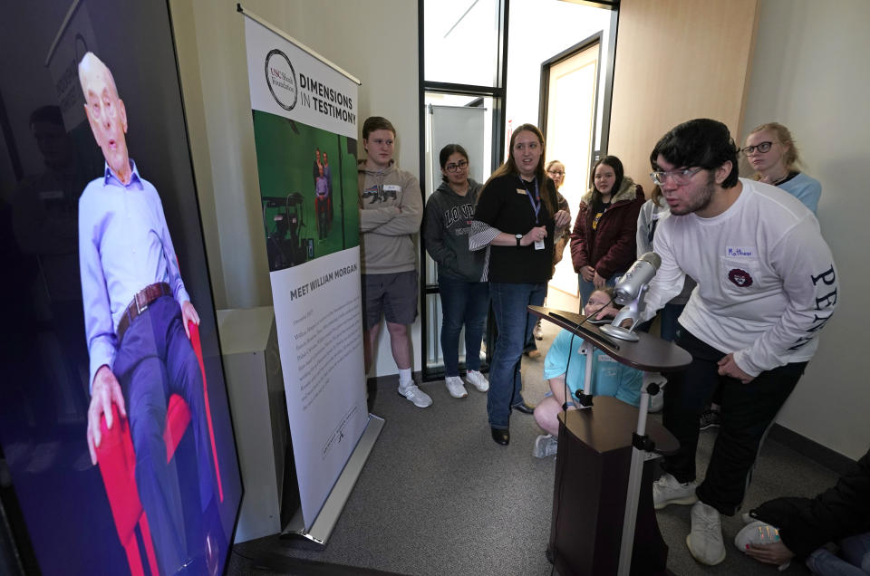 Matthew Rosca-Halmagean, 17, right, a student at Westchester Academy for International Studies, asks a question to Holocaust survivor William Morgan using an interactive virtual conversation exhibit at the the Holocaust Museum Houston Friday, Jan. 11, 2019, in Houston. The University of Southern California Shoah Foundation has recorded 18 interactive testimonies with Holocaust survivors over the last several years. (AP Photo/David J. Phillip)