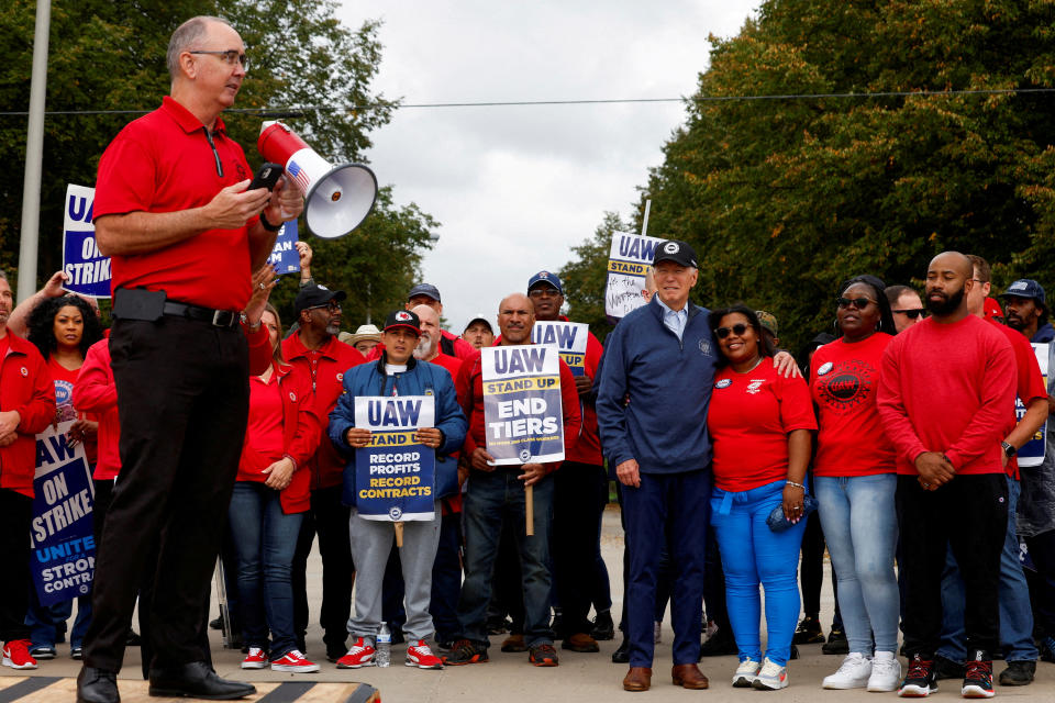 UAW President Shawn Fain and President Joe Biden on the picket line outside a GM distribution center in Belleville, Mich., in September.