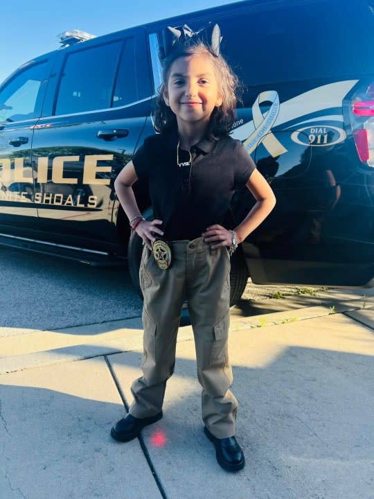 Isa Solorzano in front of Granite Shoals' new patrol car supporting children with cancer (Courtesy Orlando Solorzano)