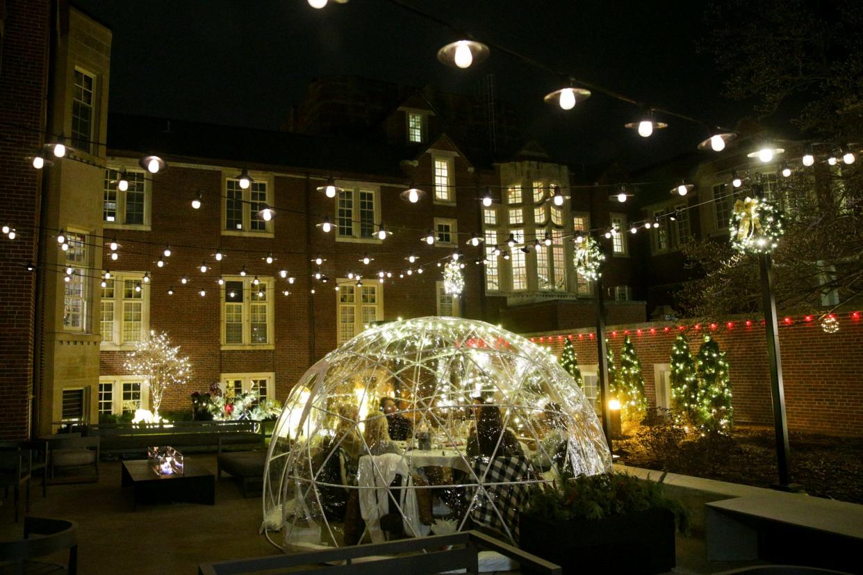 Customers enjoy drinks inside an igloo at the Purdue Union Club Hotel, Tuesday, Dec. 14, 2021 in Lafayette.