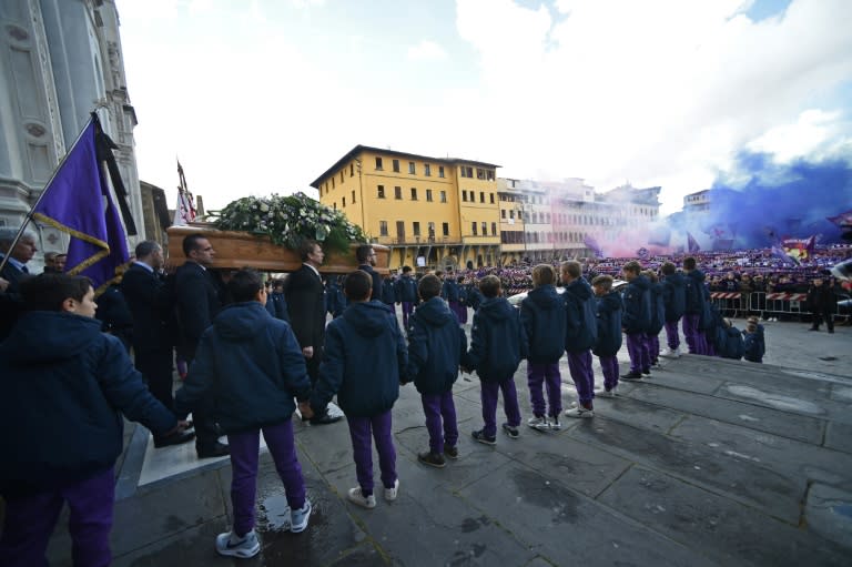 Thousands of Fiorentina supporters let off smoke flares as Davide Astori's coffin was carried out of the Santa Croce basilica in Florence after the club captain's funeral