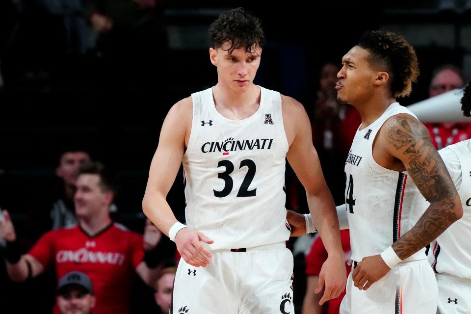 Cincinnati Bearcats guard Jeremiah Davenport (24) reacts after forward Jarrett Hensley (32) makes a stop on defense in the second half of the NCAA basketball game between the Cincinnati Bearcats and the Eastern Kentucky Colonels at Fifth Third Arena in Cincinnati on Sunday, Nov. 13, 2022. The Bearcats improved to 3-0 on the season with a 87-69 win over EKU. 