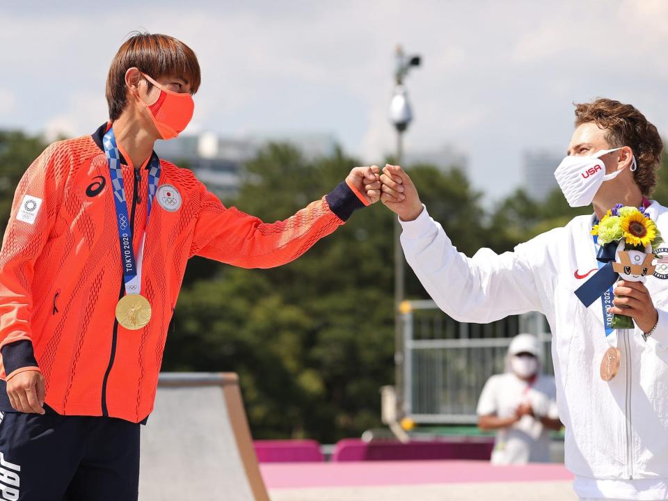 Japan's Yuto Horigome fist bumps the USA's Jagger Eaton during the medal ceremony of the men's street skateboarding final.