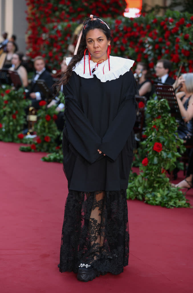 wearing a long lace skirt under an oversized tunic top with a baby doll collar