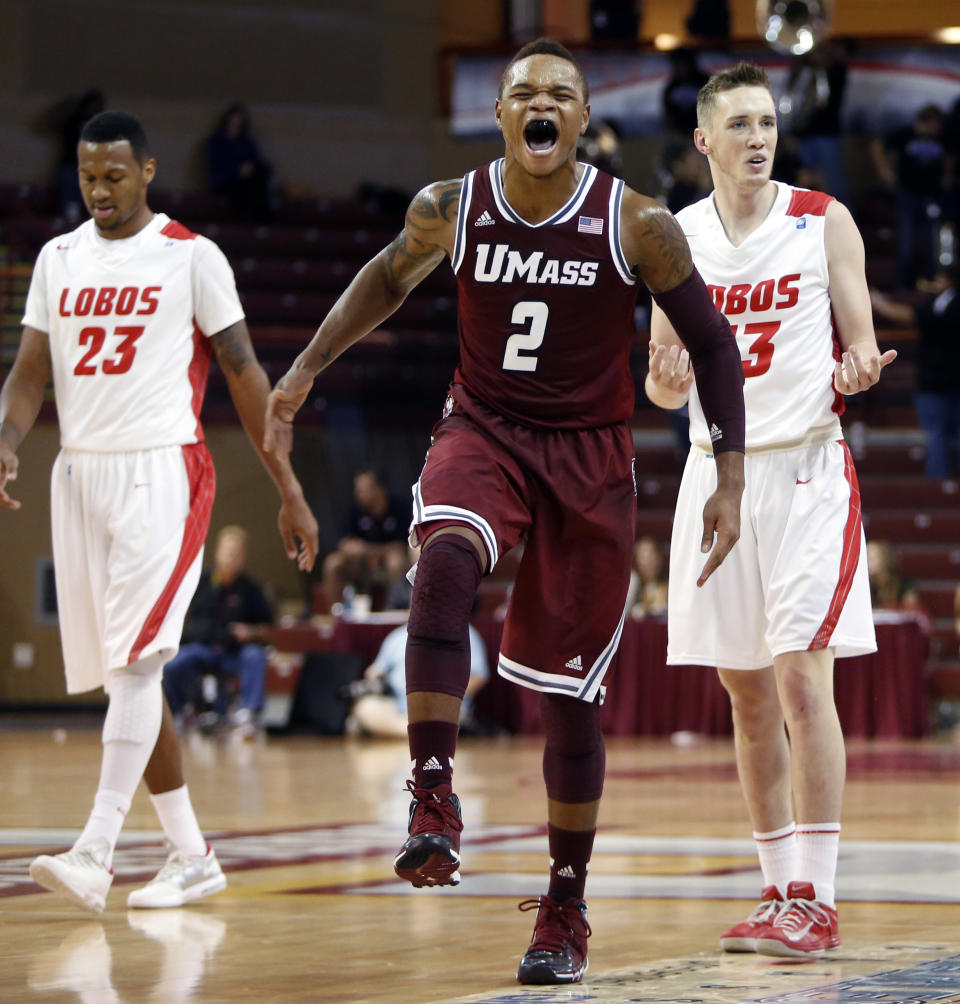 FILE - In this Nov. 22, 2013 file photo, UMass guard Derrick Gordon, center, celebrates a turnover against New Mexico's Nick Banyard, left, and Cullen Neal in the first half at the Charleston Classic NCAA college basketball tournament in Charleston, S.C. Gordon says in a televised interview that he is gay. Gordon made the announcement on ESPN on Wednesday, April 9, 2014, becoming the first openly gay player in Division I men's basketball. (AP Photo/Mic Smith, File)