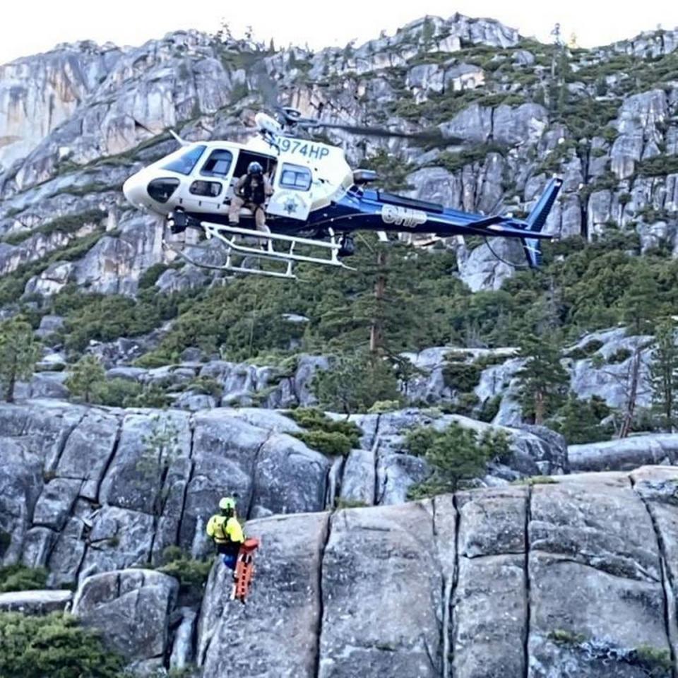 A California Highway Patrol helicopter crew works June 27 on recovering the body of hiker Juan Castaneda, who fell over a waterfall at the popular recreation area Cleo’s Bath in Tuolumne County.