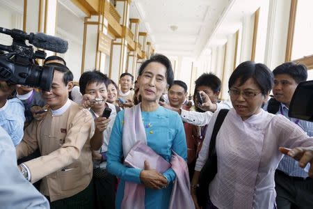 Myanmar pro-democracy and opposition leader Aung San Suu Kyi talks to the media as she attends a Parliament meeting at the Lower House of Parliament in Naypyitaw August 18, 2015. REUTERS/Soe Zeya Tun
