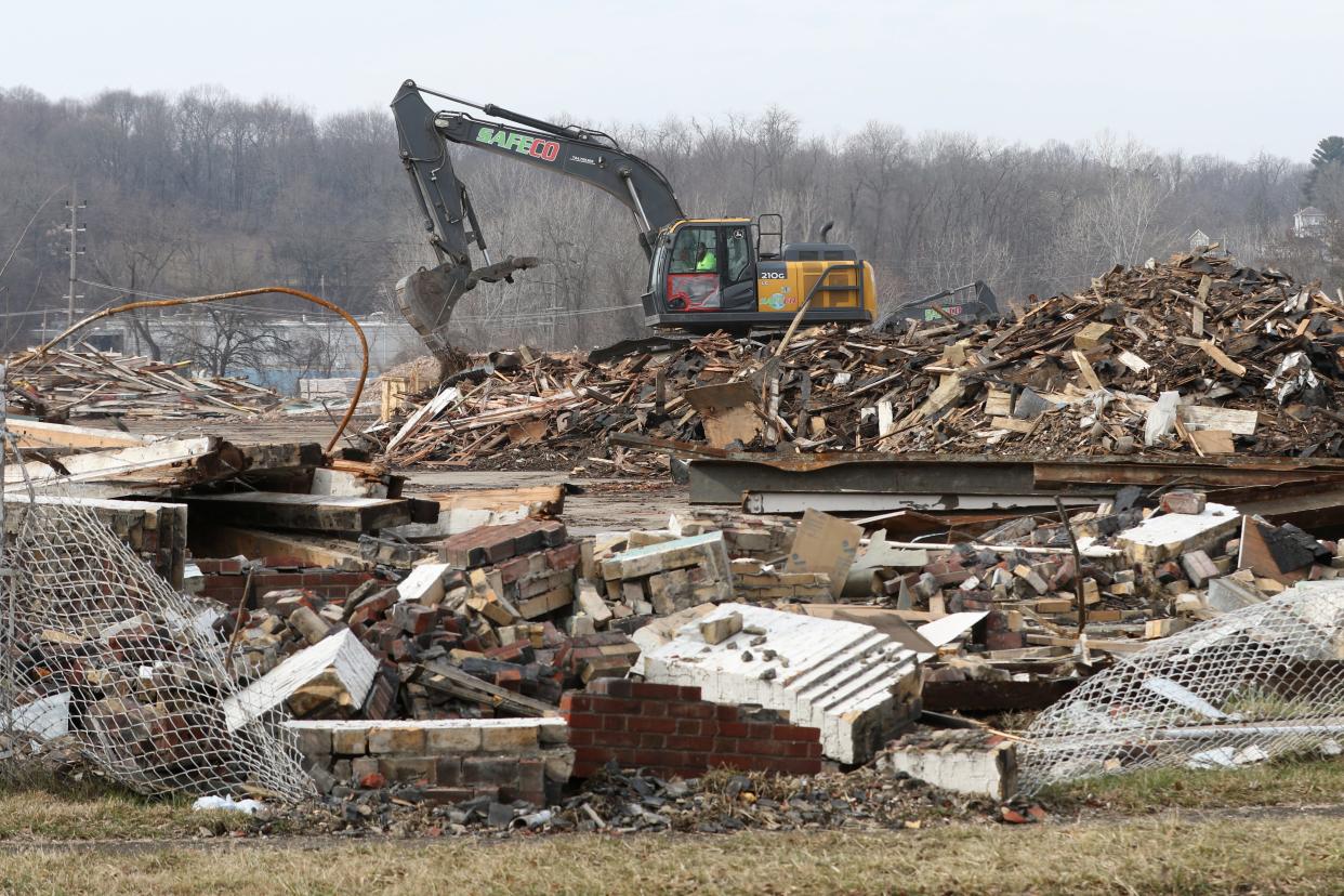 An excavator works on the former Mosaic Tile site. The Muskingum County land bank turned $200,000 into more than $2 million in grant funding to demolished blight last year. It's now going to look at redeveloping housing.