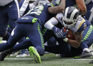 Los Angeles Rams running back Todd Gurley, right, gets past Seattle Seahawks free safety Tedric Thompson, left, to score a touchdown during the first half of an NFL football game, Sunday, Oct. 7, 2018, in Seattle. (AP Photo/Elaine Thompson)