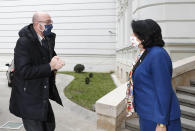 In this photo provided by the Georgian Presidential Press Office, Georgia's President Salome Zurabishvili, right, greets European Council President Charles Michel in Tbilisi, Georgia, Monday, March 1, 2021 (Georgian Presidential Press Office via AP)