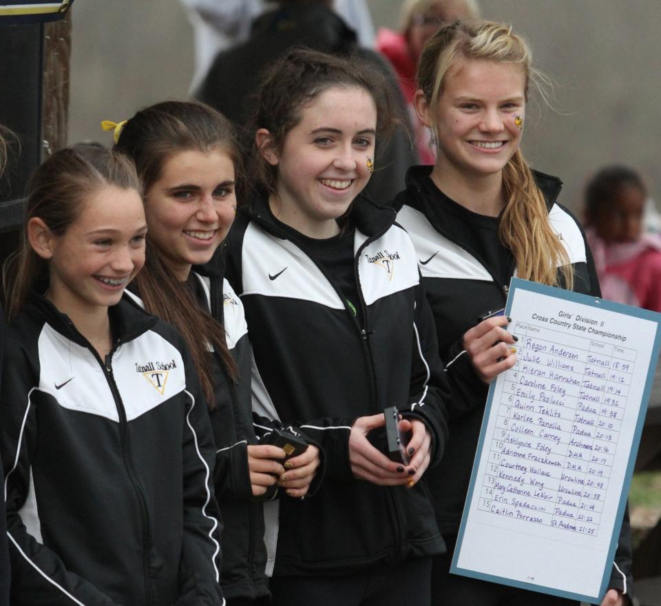 The Division II top 4 racers, all from Tatnall (from left) Caroline Foley (4th), Kieran Hanrahan (3rd), Julie Williams (2nd) and Regan Anderson (1st) pose during the awards ceremony after helping their team to the DIAA Division II girls state championship.