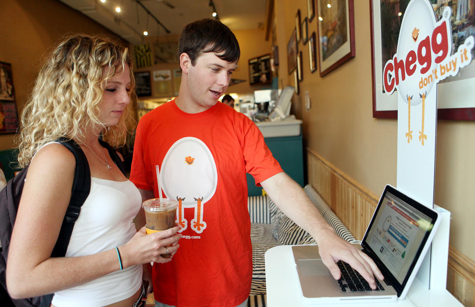 (090309 Boston, MA) Boston University student Kathleen Davies checks out the website for book rental company chegg.com at Angora Cafe on Commonwealth Avenue with chegg.com spokesperson Greg Fournier, Thursday, September 03, 2009. Staff photo by Angela Rowlings. (Photo by Angela Rowlings/MediaNews Group/Boston Herald via Getty Images)