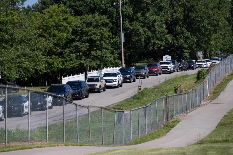 Vehicles of law enforcement, friends and family are lined up outside Scott County High School for the funeral service of Scott County Deputy Caleb Conley in Georgetown, Ky., Thursday, June 1, 2023.