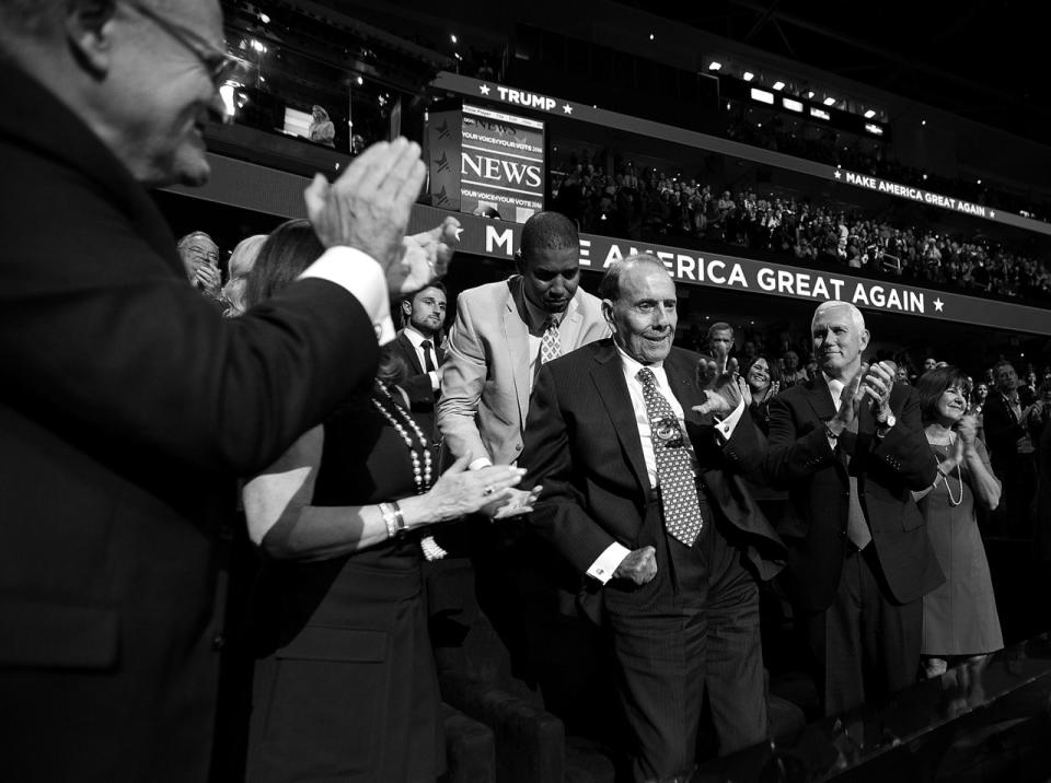 <p>Indiana Gov. Mike Pence, right, applauds former Senate Majority Leader Bob Dole, center, at the Republican National Convention on Monday. (Photo: Khue Bui for Yahoo News)</p>