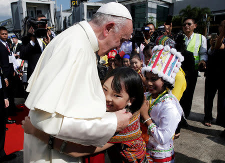 A girl embraces Pope Francis as he arrives at Yangon International Airport, Myanmar November 27, 2017. REUTERS/Max Rossi TPX IMAGES OF THE DAY