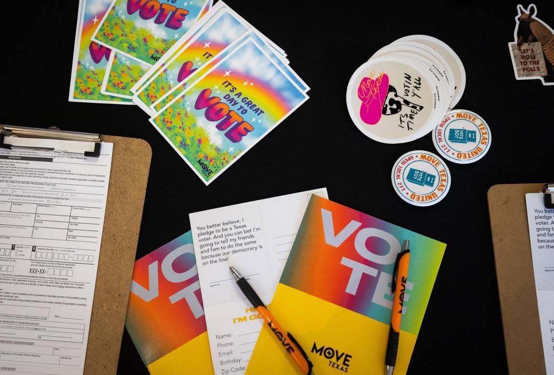 Stickers and cards are on a MOVE Texas voter registration booth on Thursday at the TCC South Campus in Fort Worth.