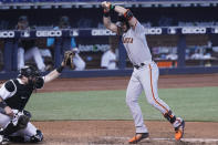 San Francisco Giants' Evan Longoria turns to avoid getting hit by a pitch as Miami Marlins catcher Chad Wallach is unable to catch the ball during the sixth inning of a baseball game, Sunday, April 18, 2021, in Miami. (AP Photo/Marta Lavandier)