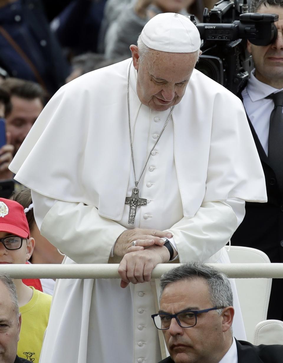 Pope Francis checks the time on his watch as he arrives for his weekly general audience, in St. Peter's Square at the Vatican, Wednesday, May 29, 2019. (AP Photo/Alessandra Tarantino)