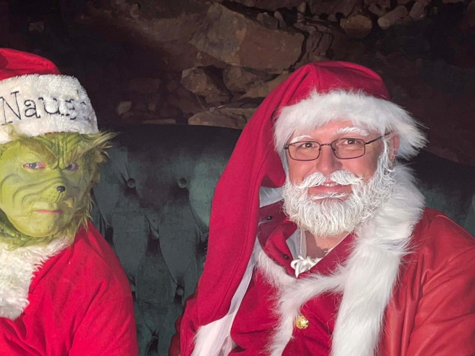 Attempting to take a picture of Santa Claus is hard work with the Grinch around at Christmas in the Cave in the Historical Cherokee Caverns Sunday, Dec. 4, 2022