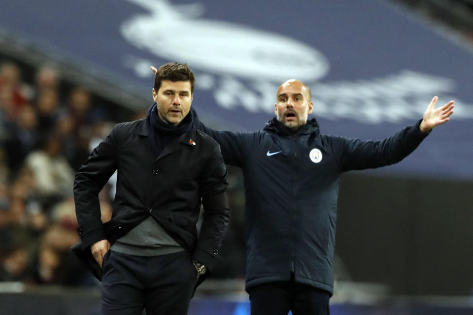 Manchester City coach Pep Guardiola, right, gesture on the sidelines next to Tottenham manager Mauricio Pochettino during the English Premier League soccer match between Tottenham Hotspur and Manchester City at Wembley stadium in London, England, Monday, Oct. 29, 2018. (AP Photo/Alastair Grant)